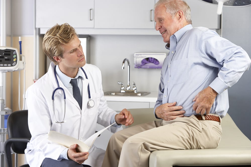 Doctor Examining Male Patient with Hip Pain