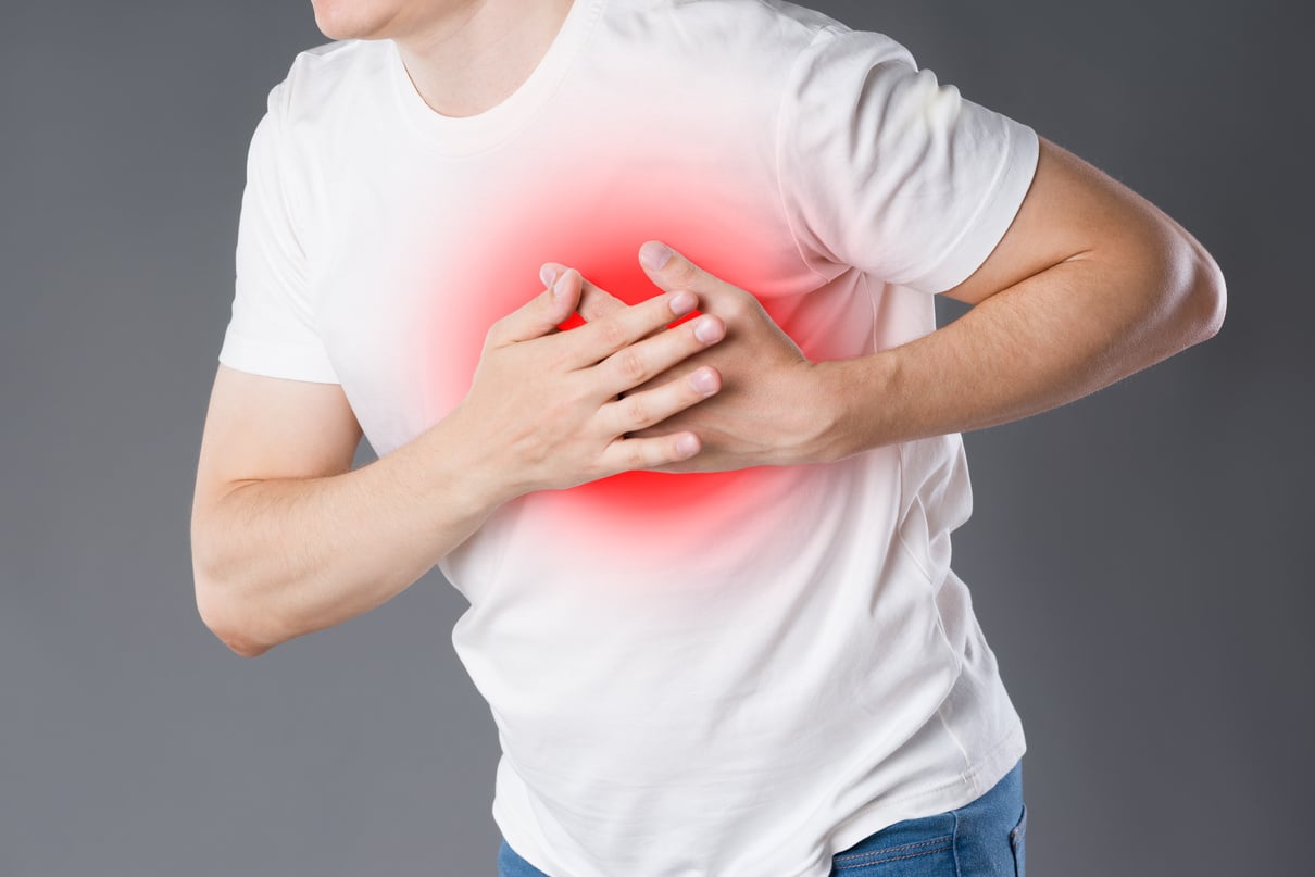 Heart attack, man with chest pain on gray background